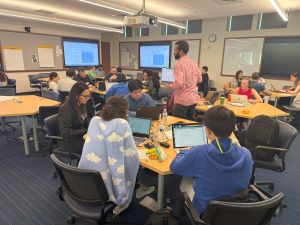 datathon teams at separate tables in a conference room