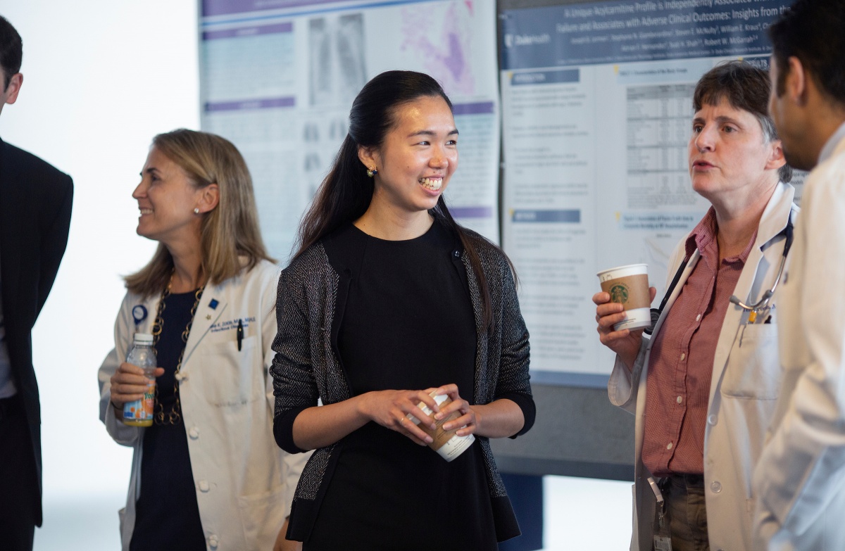 Residents look at posters at research event