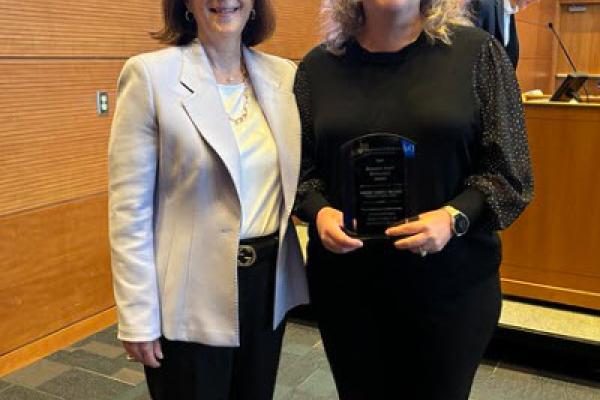 Dr. Cooney standing with Christy Walters with award