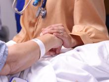 Patient and provider holding hands
